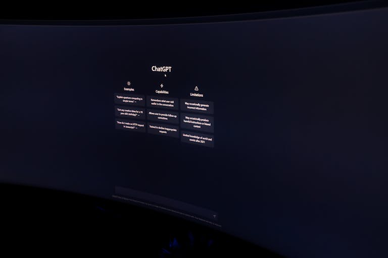 A dark, minimalist photo of a computer monitor displaying the ChatGPT interface.